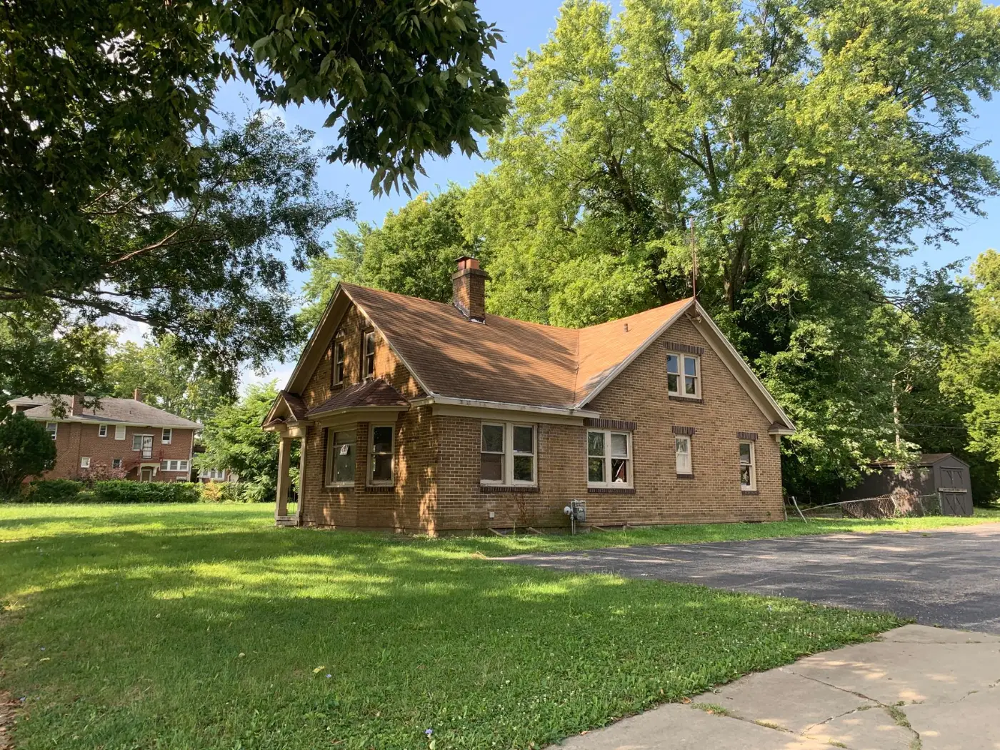 Established brick home shaded by mature neighborhood trees